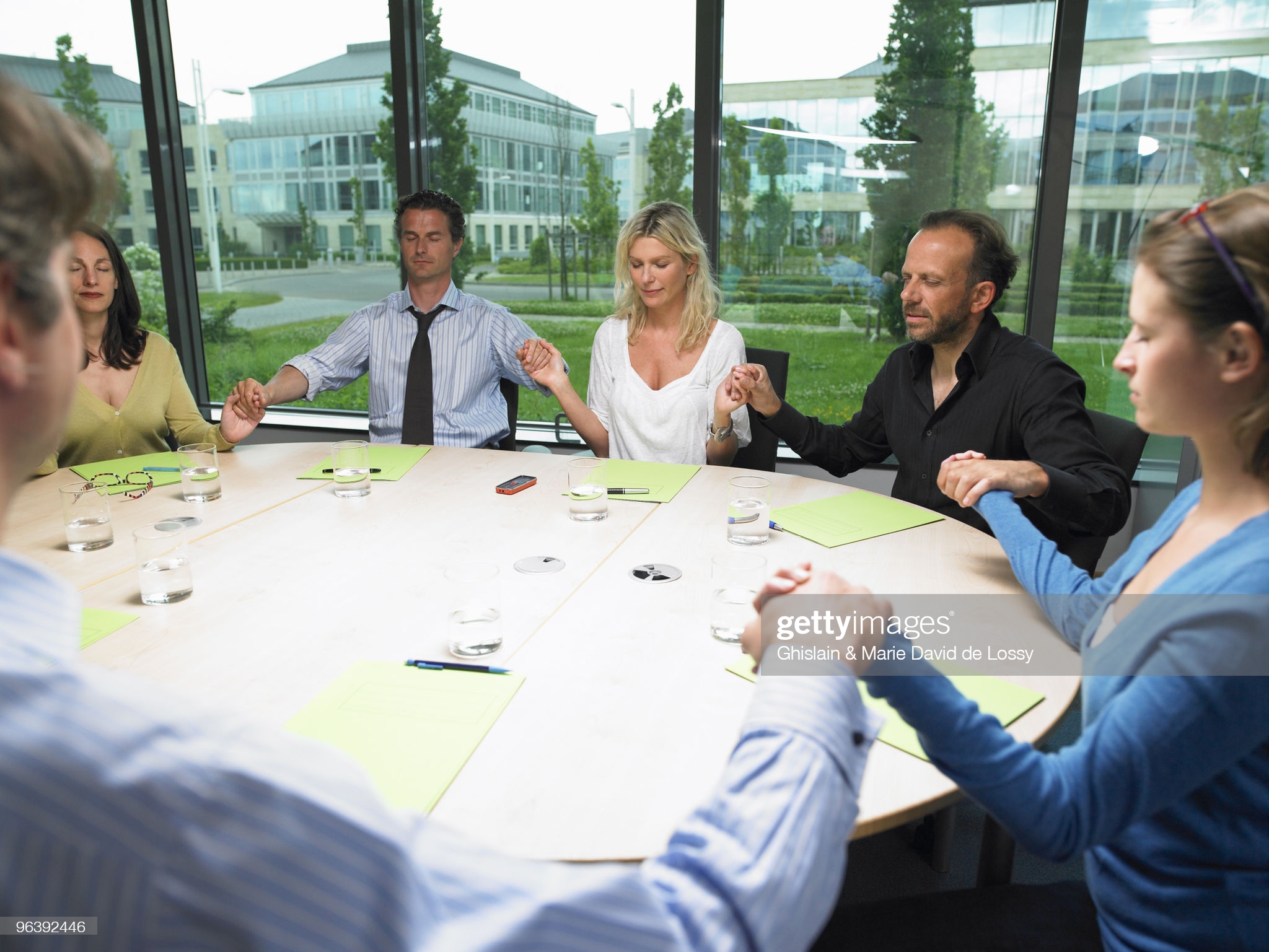 Coworkers holding hands - stock photo. Getty Images, Ghislain & Marie David de Lossy.